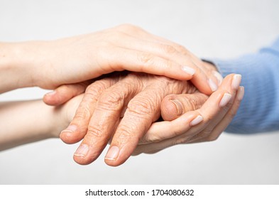 Young hands hold old hands. Support for the elderly concept. 