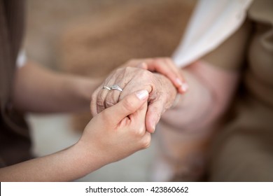 Young Hands Holding An Old Hands