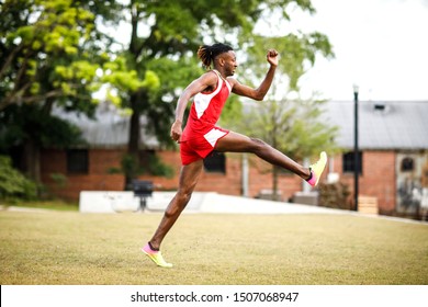 Young Handsome African American Black Male Outside Running In The Field Of A Small Town In Georgia City Ampitheater. Track And Field Star