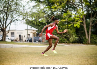 Young Handsome African American Black Male Outside Running In The Field Of A Small Town In Georgia City Ampitheater. Track And Field Star