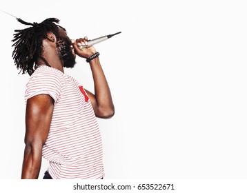 young handsome african american boy singing emotional with microphone isolated on white background, in motion gesturing smiling, lifestyle people concept  - Powered by Shutterstock