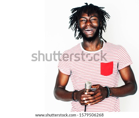 young handsome african american boy singing emotional with microphone isolated on white background, in motion gesturing smiling closeup. karaoke singer