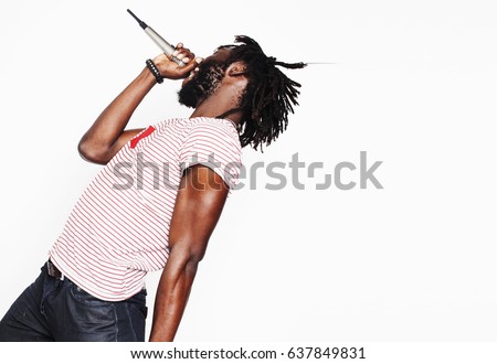young handsome african american boy singing emotional with microphone isolated on white background, in motion gesturing smiling, lifestyle people concept 