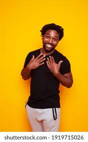 Young Handsome African American Guy Student Posing Cheerful And Gesturing On Yellow Background, Lifestyle People Concept