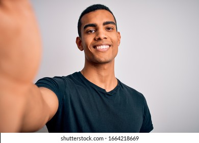 Young Handsome African American Man Wearing Casual T-shirt Making Selfie By Camera With A Happy Face Standing And Smiling With A Confident Smile Showing Teeth