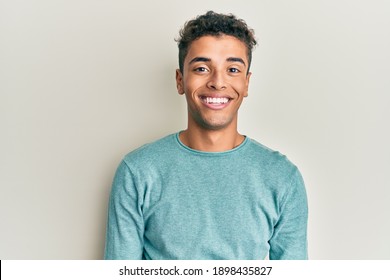 Young handsome african american man wearing casual clothes with a happy and cool smile on face. lucky person. 