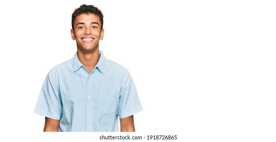 Young handsome african american man wearing casual clothes with a happy and cool smile on face. lucky person. 