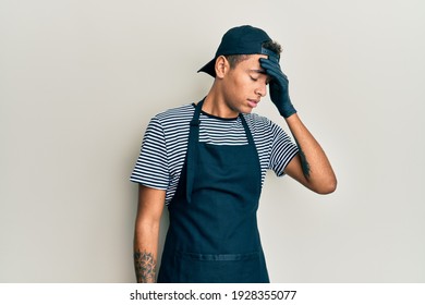 Young Handsome African American Man Tattoo Artist Wearing Professional Uniform And Gloves Surprised With Hand On Head For Mistake, Remember Error. Forgot, Bad Memory Concept. 