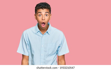 Young handsome african american man wearing casual clothes afraid and shocked with surprise and amazed expression, fear and excited face. 