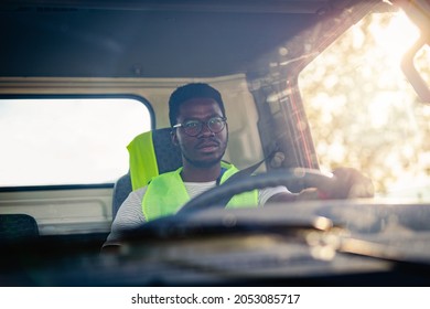 Young Handsome African American Man Working In Towing Service And Driving His Truck.