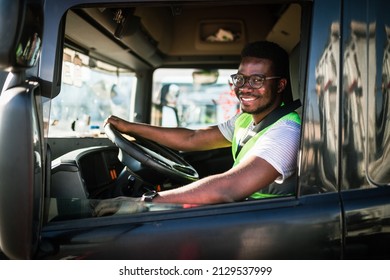 Young handsome African American man working in towing service and driving his truck. - Shutterstock ID 2129537999