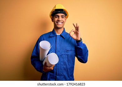 Young handsome african american optical man holding optometry glasses over blue background doing ok sign with fingers, excellent symbol - Shutterstock ID 1792416823