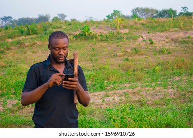 Young Handsome African Farmer Checking Some Deals On His Phone