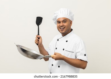 Young Handsome Asian Man Chef In Uniform Holding Turner And Iron Frying Pan Utensils Cooking In The Kitchen Various Gesture On Isolated Background. Indian Man Occupation Chef Restaurant And Hotel.