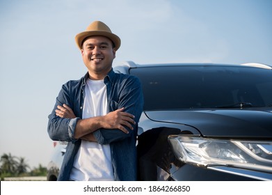 Young Handsome Asian Man Getting The New Car.He Standing In Front Of The Car.He Very Happy. Buy Or Rent A Car Concept.