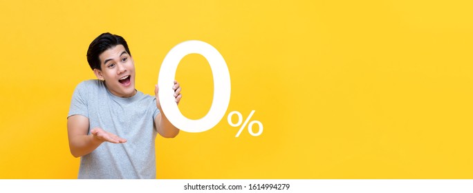 Young Handsome Asian Man Offer 0% On Yellow Banner Background With Copy Space For No Interest Installment Payment Concept