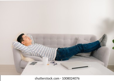 Young handsome asian man sleeping on sofa. - Powered by Shutterstock