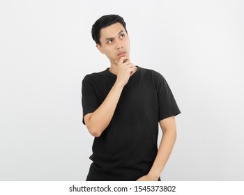 Young Handsome Asian Man Thinking An Idea While Looking Up Isolated On White Background.