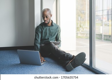 Young handsome black man indoor smart working - business, freelancer, self isolation concept - Shutterstock ID 1705635754