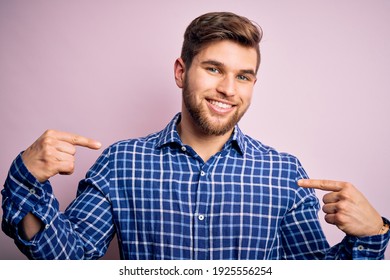 Young handsome blond man with beard and blue eyes wearing casual shirt standing looking confident with smile on face, pointing oneself with fingers proud and happy.
