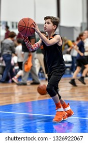 Young handsome boy playing in a basketball game
