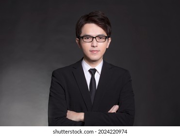 Young Handsome Buisness Man In Black Suit And Wearing Eyeglasses