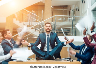 young handsome business man in black suit practice yoga and relax at office while representing stress control concept