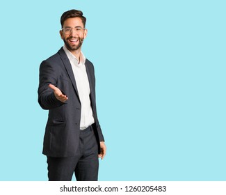 Young Handsome Business Man Reaching Out To Greet Someone