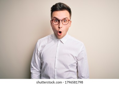 Young Handsome Business Mas Wearing Glasses And Elegant Shirt Over Isolated Background Afraid And Shocked With Surprise Expression, Fear And Excited Face.