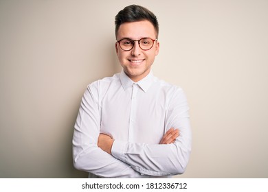 Young Handsome Business Mas Wearing Glasses And Elegant Shirt Over Isolated Background Happy Face Smiling With Crossed Arms Looking At The Camera. Positive Person.