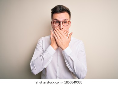 Young Handsome Business Mas Wearing Glasses And Elegant Shirt Over Isolated Background Shocked Covering Mouth With Hands For Mistake. Secret Concept.