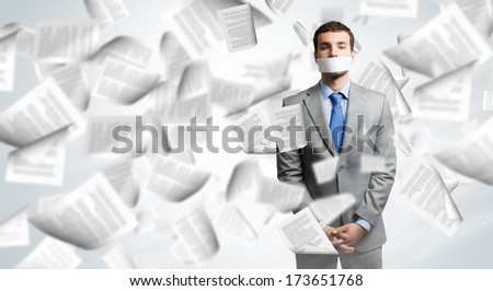 Young handsome businessman with adhesive tape on mouth