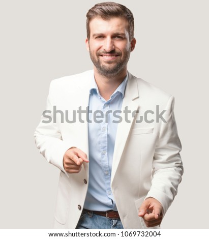 young handsome businessman dancing, white blazer, happy or satisfied expression . person isolated against monochrome background