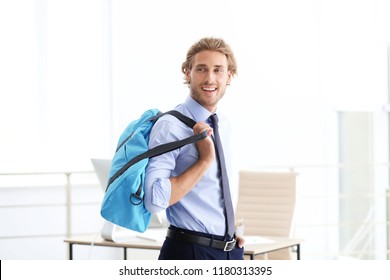 Young Handsome Businessman Holding Fitness Bag In Office. Gym After Work