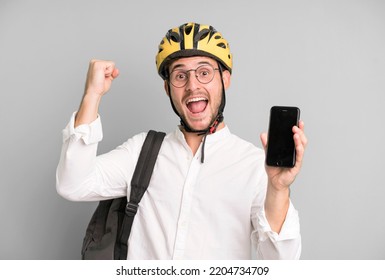 Young Handsome Businessman Isolated With A Bike Helmet