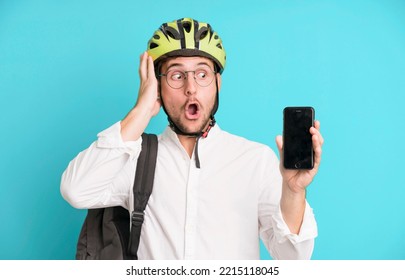 Young Handsome Businessman Isolated With A Bike Helmet