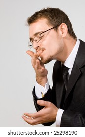 Young Handsome Businessman Licking Fingers