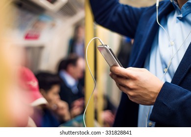 Young handsome businessman with smartphone in subway - Powered by Shutterstock