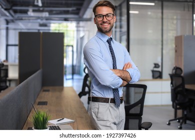 Young Handsome Businessman Smiling In An Office Environment