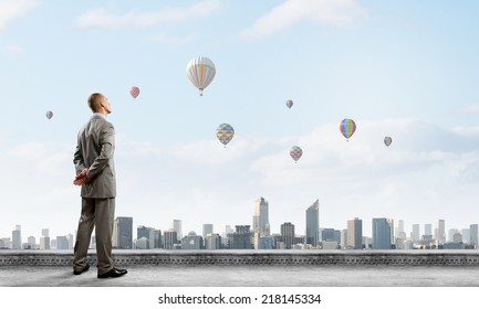 Young Handsome Businessman Standing On Top Of Building