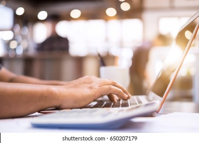Young handsome businessman using laptop for search information his work at cafe - Shutterstock ID 650207179
