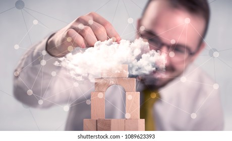 Young Handsome Businessman Using Wooden Building Blocks Behind Cloud Concept 