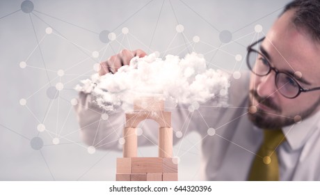 Young Handsome Businessman Using Wooden Building Blocks Behind Cloud Concept 