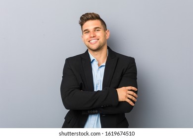 Young handsome caucasian man who feels confident, crossing arms with determination. - Shutterstock ID 1619674510