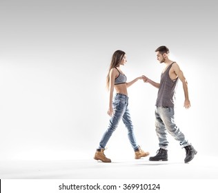 young handsome couple dancing hip-hop, studio background - Powered by Shutterstock