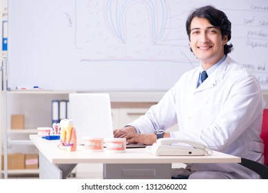 Young handsome dentist in front of the whiteboard