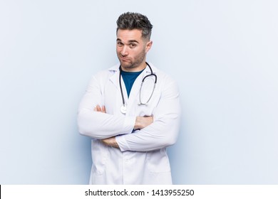 Young Handsome Doctor Man Unhappy Looking In Camera With Sarcastic Expression.