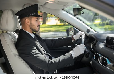 Young Handsome Driver In Luxury Car. Chauffeur Service