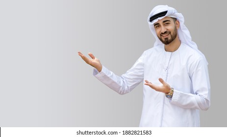 Young handsome Emirati business man in UAE traditional outfit showing a variety of hand gesture. Arabic ambitious mature businessman.