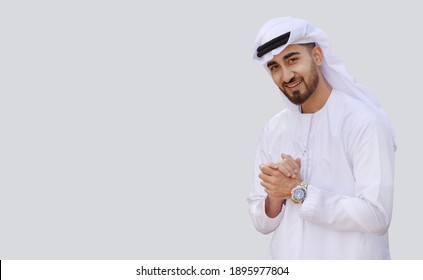 Young handsome Emirati business man in UAE traditional outfit showing a variety of hand gesture. Arabic ambitious mature businessman